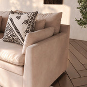 Khaki sofa curved armrest and seat detail — lifestyle scene