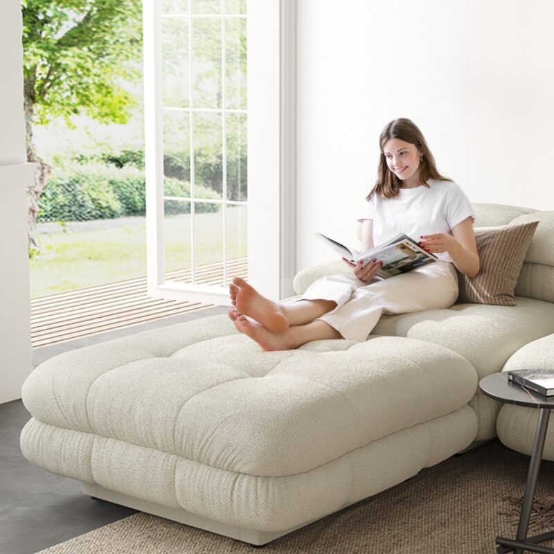 a woman sits on a sofa