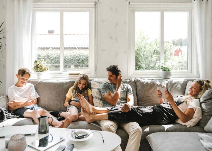 Happy family sitting on deep sofa in living room