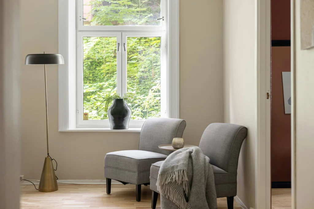 A Chaise Sectional Modular Sofa Along The Window