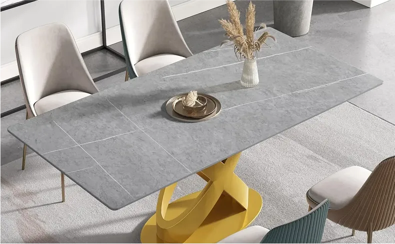 Grey sintered stone dining table with steel base displaying its modern design and durable construction