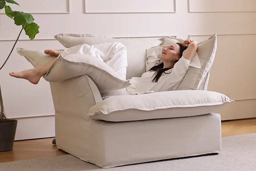 Person relaxing in lounging position with cushion support